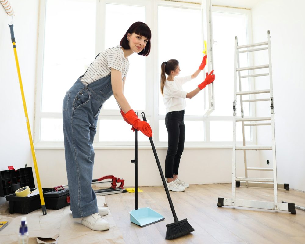 Young beautiful women cleaning up new apartment after renovation.